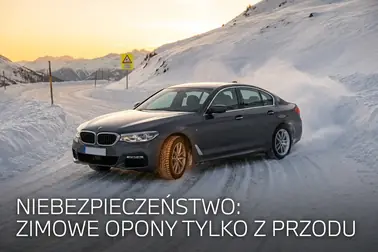 Samochód w zakręcie z zimowymi oponami z przodu i uślizgiem tylnej osi