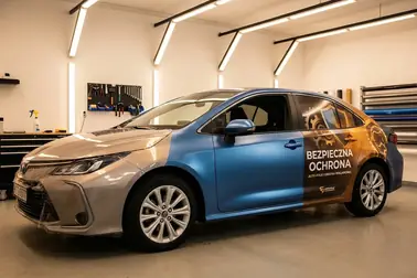Samochód z zaznaczonymi obszarami pełnego oklejenia, częściowego zabezpieczenia i grafiki reklamowej
