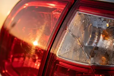Tylna lampa z płytkimi rysami oraz lampa z pęknięciem i wilgocią wewnątrz
